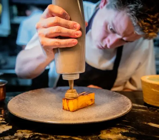 Larder chef Alex adding the fishing touches on a dessert